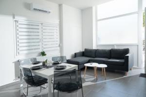 a living room with a couch and a table and chairs at Harmony in Perea