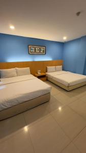 Postel nebo postele na pokoji v ubytování South of The Clouds HOTEL KL Sentral 吉隆坡彩云之南酒店-中央车站店