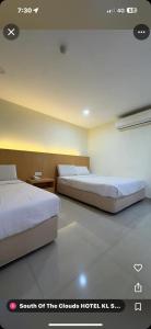 Postel nebo postele na pokoji v ubytování South of The Clouds HOTEL KL Sentral 吉隆坡彩云之南酒店-中央车站店