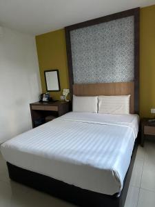 Postel nebo postele na pokoji v ubytování South of The Clouds HOTEL KL Sentral 吉隆坡彩云之南酒店-中央车站店