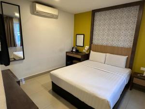 Postel nebo postele na pokoji v ubytování South of The Clouds HOTEL KL Sentral 吉隆坡彩云之南酒店-中央车站店