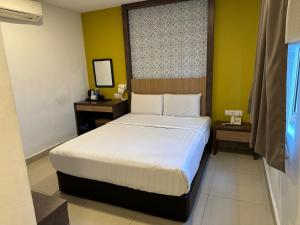 Postel nebo postele na pokoji v ubytování South of The Clouds HOTEL KL Sentral 吉隆坡彩云之南酒店-中央车站店