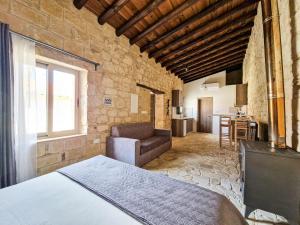 a bedroom with a bed and a couch in a room at Andre Marie Stonewood Retreat in Limassol