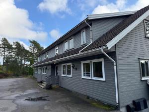 a gray house with a lot of windows at Agder Folkehøgskole - Gjestehus in Kristiansand +2 photos