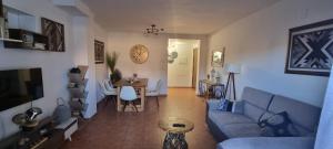 a living room with a blue couch and a table at Wood, Wine & Golf in Sojuela