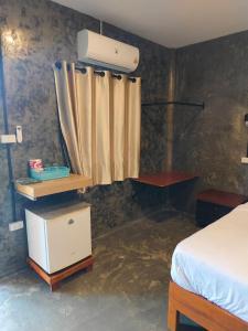 a bedroom with a bed and a heater and a curtain at Hubkhao Resort in Ko Lanta