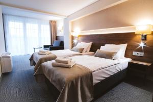 Postel nebo postele na pokoji v ubytování Hotel Piotr Spa&Wellness