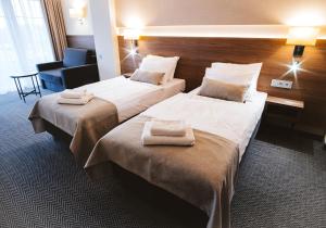 Postel nebo postele na pokoji v ubytování Hotel Piotr Spa&Wellness