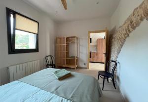 a bedroom with a bed and a window and a door at Mas de Muntaner in Tivissa