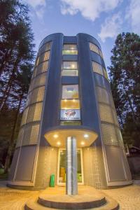 a building with a column in front of it at Hakuba Eagle Lodge in Hakuba
