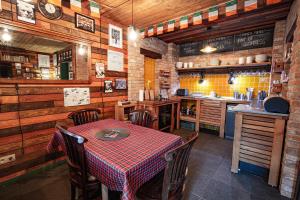 a restaurant with a table and chairs and a kitchen at Liptov Lodge in Liptovský Mikuláš