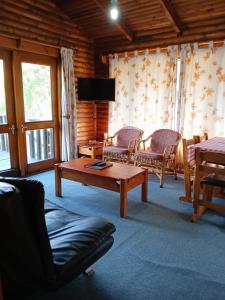 a living room with a couch and a coffee table at Eland Valley Resort in Underberg