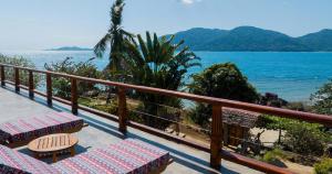 a balcony with chairs and a view of the ocean at Villa Nausicaa in Nosy Komba