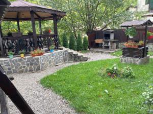 a garden with a gazebo and some plants at Chez Marcel Sinaia in Sinaia