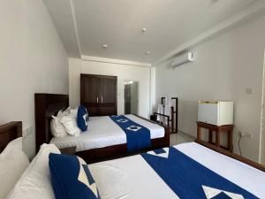 Katil atau katil-katil dalam bilik di Nico Beach Hotel