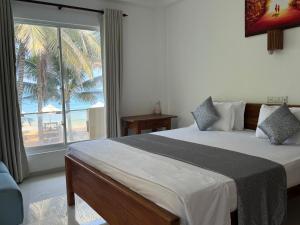 Katil atau katil-katil dalam bilik di Nico Beach Hotel