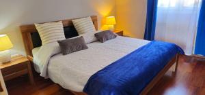 a bedroom with a large bed with two lamps on it at Apartments Tena in Rovinj