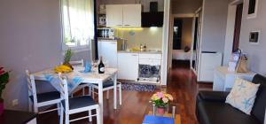 a kitchen and a living room with a table with bananas on it at Apartments Tena in Rovinj