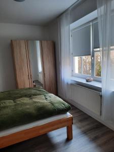 a bedroom with a bed and a window at Gemütliches Nest in bester Kölner City-Wohnlage in Cologne