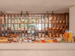a buffet with many plates of food on a counter at Hôtel Liautaud Rooftop Cassis in Cassis