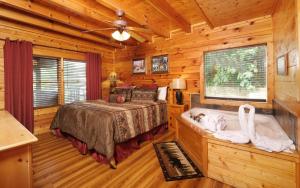 a bedroom with a bed and a bath tub in a room at Bear Retreat in Pigeon Forge +47 photos