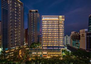 a city skyline with tall buildings at night at InterContinental Taichung by IHG in Taichung