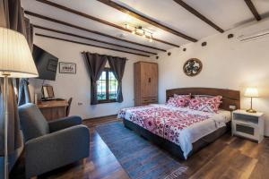a bedroom with a bed and a chair at Villa Viara in Pchelnik +23 photos