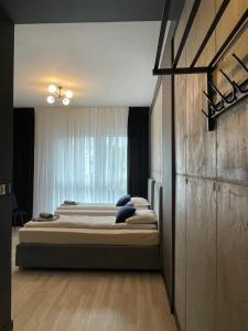 a bedroom with two beds and a window at Nowoczesne Apartamenty Stare Miasto in Częstochowa +40 photos