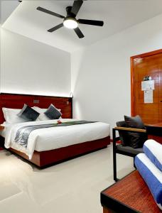 a bedroom with a bed and a ceiling fan at Baa Sand Maldives in Kudarikilu +38 photos