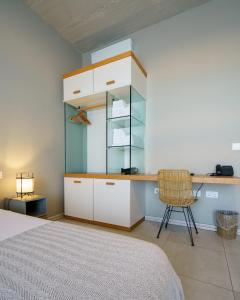 a bedroom with a bed and a desk and a chair at Villa dei Venti in Qala
