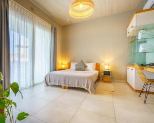 a bedroom with a bed and a large window at Villa dei Venti in Qala