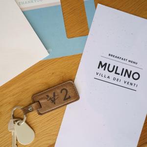 a key on a table with ailla deventer card at Villa dei Venti in Qala