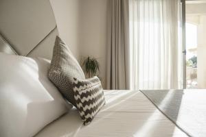 two pillows sitting on a bed in a room at Villa dei Venti in Qala