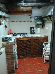 a kitchen with a stove and a counter with plates at Casa Orencio, bosque encantado de Parauta in Parauta +11 photos