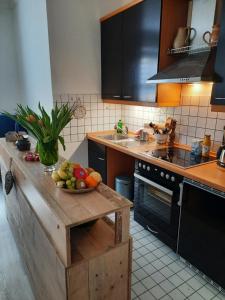 a kitchen with a bowl of fruit on a counter at Gemütliches Nest in bester Kölner City-Wohnlage in Cologne