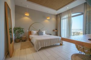 a bedroom with a large bed and a large window at Villa dei Venti in Qala +37 photos