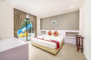 a bedroom with a large bed and a window at Villa Navin in Jomtien Beach +91 photos