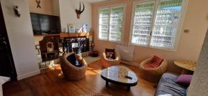 a living room with a couch and chairs and a table at Maison familiale in Ax-les-Thermes