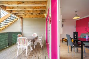a room with a table and chairs on a deck at Rochefort in Saint-Simon-de-Bordes