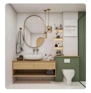 a bathroom with a sink and a mirror and a toilet at Luxury & Stylish Apt Rasuna 2BR with Pool n Gym by 2ndHome in Jakarta