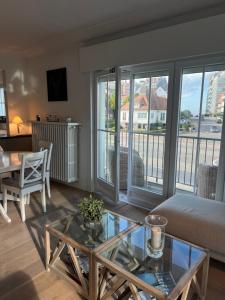 a living room with a couch and a glass table at Mar y sal in Knokke-Heist +8 photos