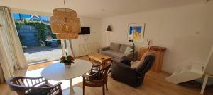 a living room with a table and a couch at zilvermeeuw in Bergen aan Zee +8 photos