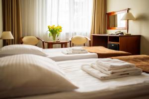 Posteľ alebo postele v izbe v ubytovaní Hotel Zawisza