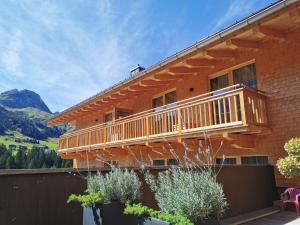 a house with a deck on the side of it at Naturhaus am Arlberg in Warth am Arlberg