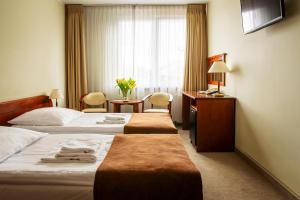Posteľ alebo postele v izbe v ubytovaní Hotel Zawisza