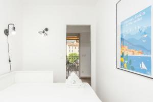 a room with two beds and a poster on the wall at "Le beach", plein centre, climatisé in Menton