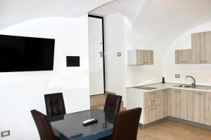 a dining room with a table and chairs and a tv at C'est La Vie in Caserta