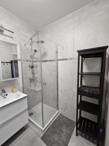 a bathroom with a shower with a sink and a shower at PB EasyStay in Szczytno +9 photos
