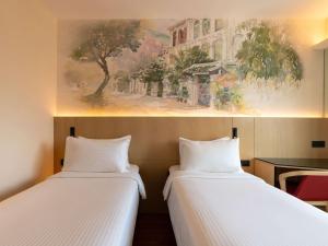 Ibis Singapore on Bencoolen - Newly Renovated客房内的一张或多张床位