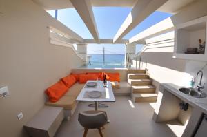 a room with a couch and a table and a sink at Agios Gordios Beach Resort in Agios Gordios
